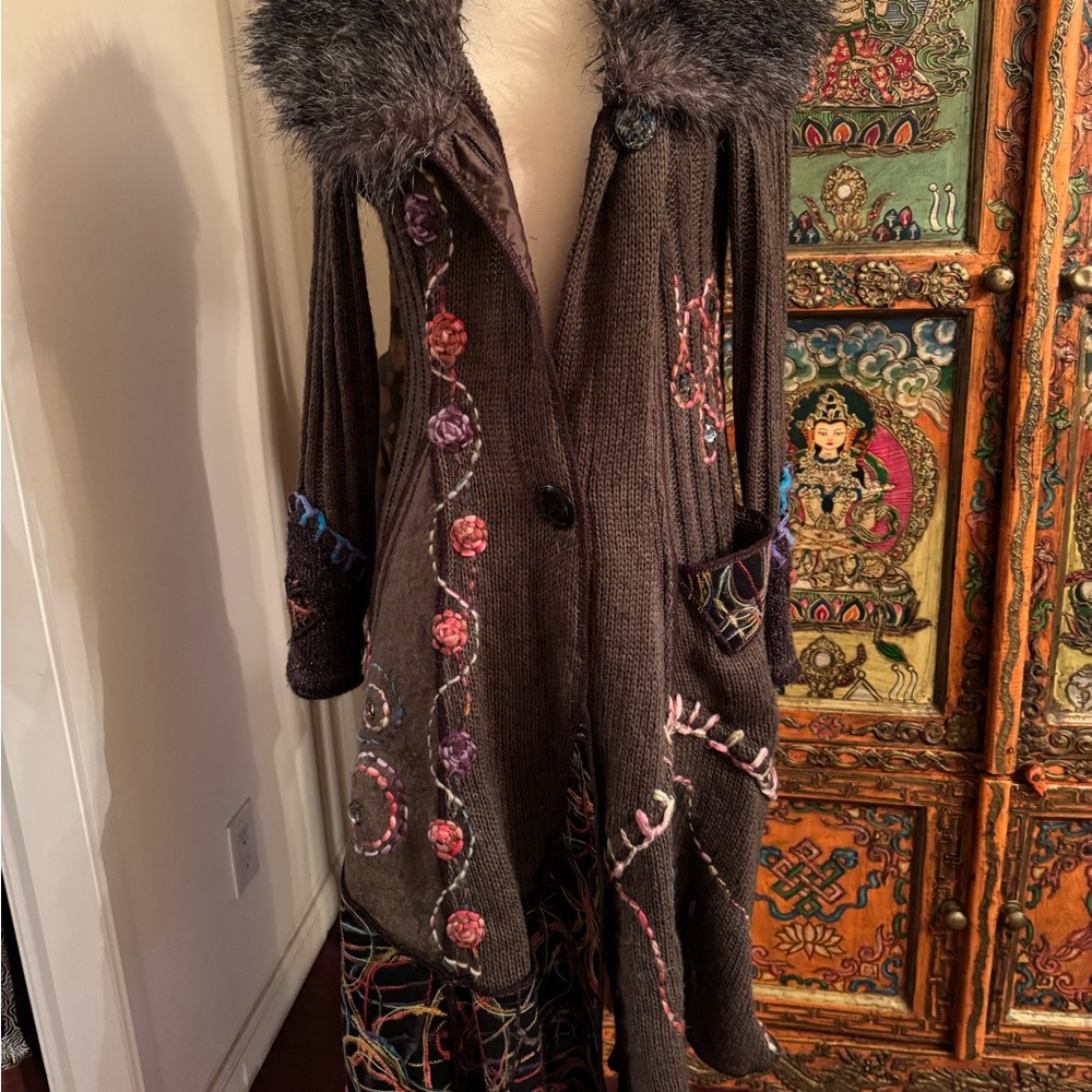 A beautiful multi colored sweater jacket.  Fur color and embroidered details